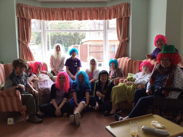 Staff and residents wearing fun wigs