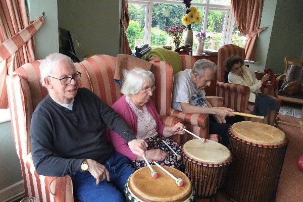 Care home residents playing drums
